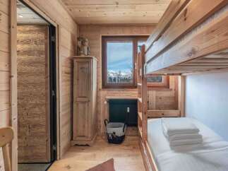 Step into this cozy mountain retreat, featuring a charming bunk bed perfect for family or guests.