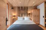 Step into a cozy bedroom retreat, featuring warm wooden accents and a rustic charm.
