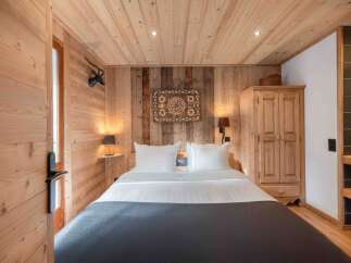 Step into a cozy bedroom retreat, featuring warm wooden accents and a rustic charm.