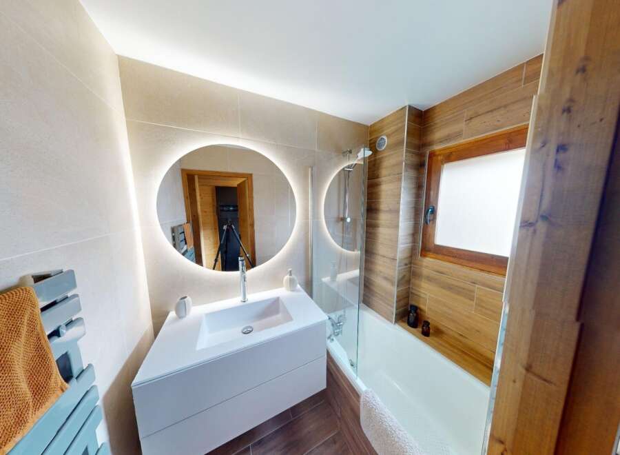 Step into this beautifully designed bathroom featuring a modern aesthetic and luxurious finishes.