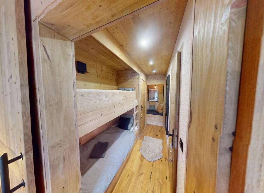 Step into this cozy cabin retreat, featuring a charming bunk bed setup perfect for family or friends.
