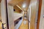 Step into this cozy cabin retreat, featuring a charming bunk bed setup perfect for family or friends.