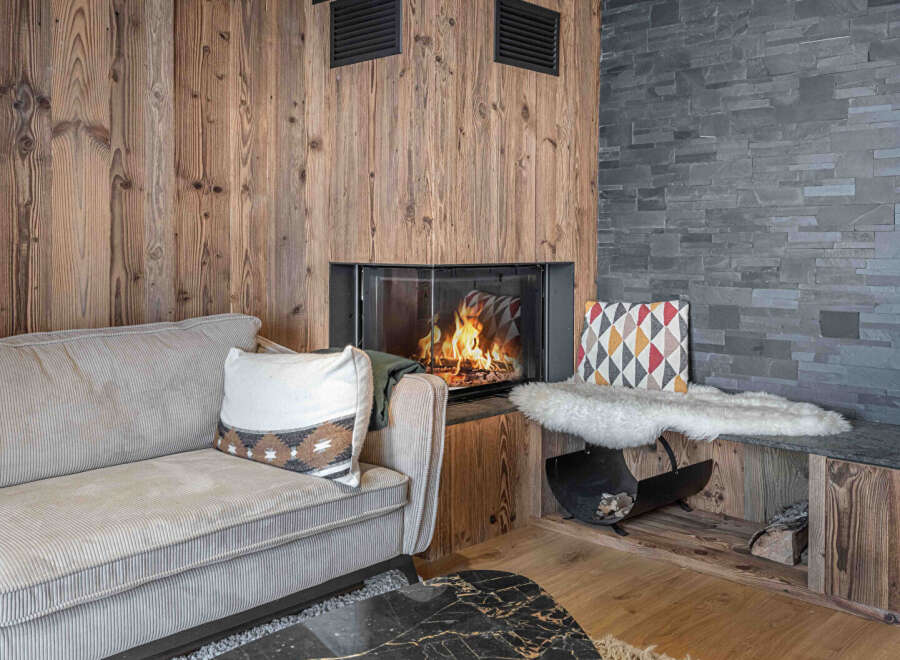 Cozy up in this stunning living space featuring a beautiful fireplace and rustic wood accents.