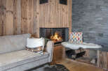 Cozy up in this stunning living space featuring a beautiful fireplace and rustic wood accents.