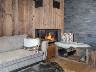 Cozy up in this stunning living space featuring a beautiful fireplace and rustic wood accents.