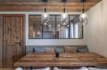 This stunning dining area showcases rustic charm with its wooden table and ceiling beams.