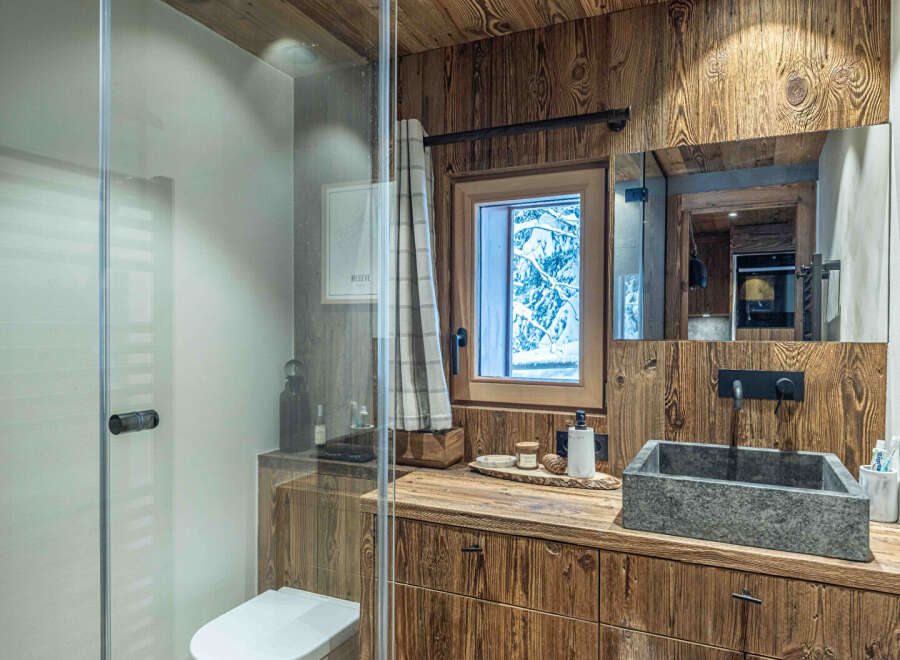 This stunning bathroom showcases rustic charm with its wooden accents and a modern touch.