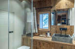 This stunning bathroom showcases rustic charm with its wooden accents and a modern touch.