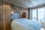 This cozy bedroom features a rustic wooden design, creating a warm and inviting atmosphere.