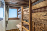 This charming bedroom features rustic bunk beds crafted from beautiful wood, creating a cozy and inviting space.