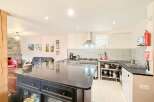 This stunning kitchen boasts a sleek, modern design with a large island perfect for meal preparation and entertaining.