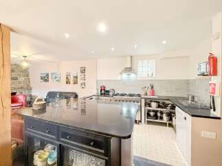 This stunning kitchen boasts a sleek, modern design with a large island perfect for meal preparation and entertaining.