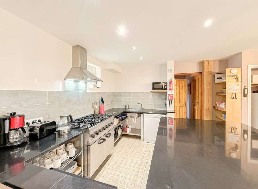 This spacious kitchen boasts a sleek, modern design with ample counter space and stainless steel appliances.