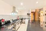 This spacious kitchen boasts a sleek, modern design with ample counter space and stainless steel appliances.