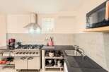 This kitchen boasts a professional-grade gas range, perfect for culinary enthusiasts.