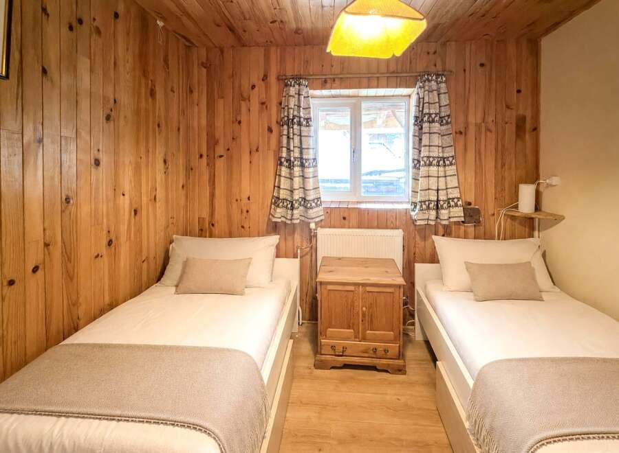 This cozy bedroom features two twin beds, perfect for guests or a shared living space.