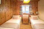 This cozy bedroom features two twin beds, perfect for guests or a shared living space.