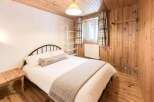 This cozy bedroom features a rustic wooden interior, creating a warm and inviting atmosphere.