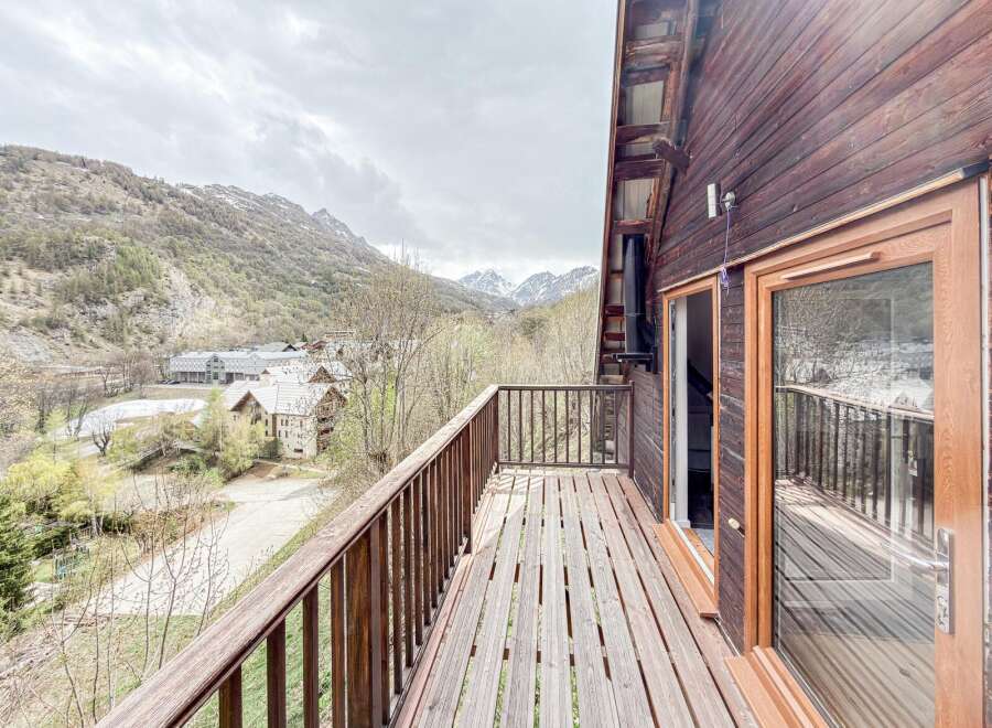 Enjoy breathtaking mountain views from this charming chalet's balcony.