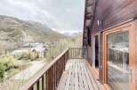 Enjoy breathtaking mountain views from this charming chalet's balcony.
