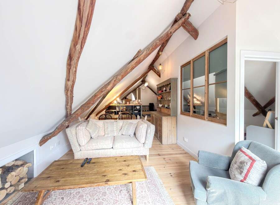 Discover the charm of this unique property featuring exposed wooden beams and a cozy living space.