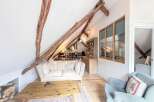 Discover the charm of this unique property featuring exposed wooden beams and a cozy living space.