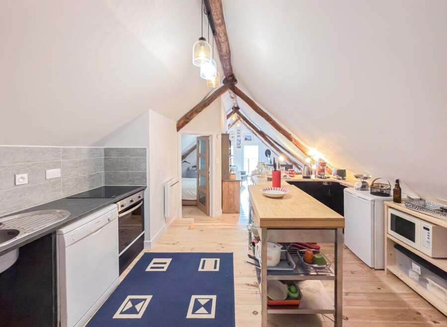 Discover this charming attic kitchen, perfect for cozy living.