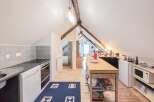 Discover this charming attic kitchen, perfect for cozy living.