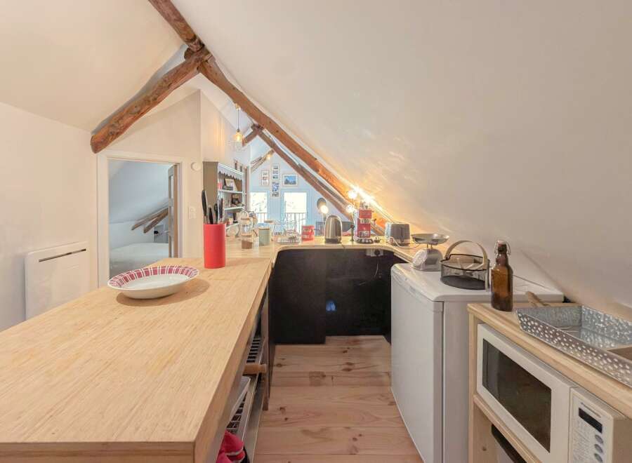 Discover the charm of this unique property with its cozy kitchen, perfect for culinary adventures.