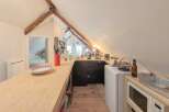 Discover the charm of this unique property with its cozy kitchen, perfect for culinary adventures.