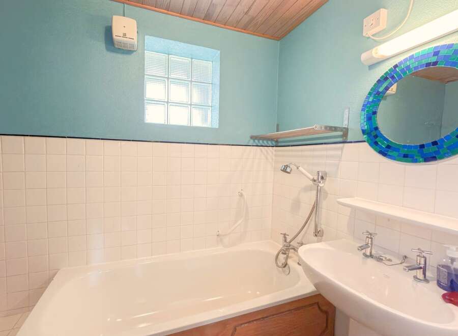 This charming bathroom features a classic design with a touch of modern flair.