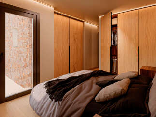 Step into luxury with this stunning bedroom featuring custom wooden cabinetry and a cozy, inviting atmosphere.