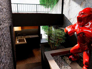 Discover modern luxury in this stunning property, featuring a unique design with a striking red gorilla sculpture.