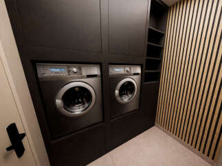 Discover the epitome of modern convenience with this stunning laundry room.