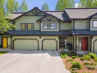 Discover this charming property featuring a beautiful exterior with a light green color and dark brown accents.