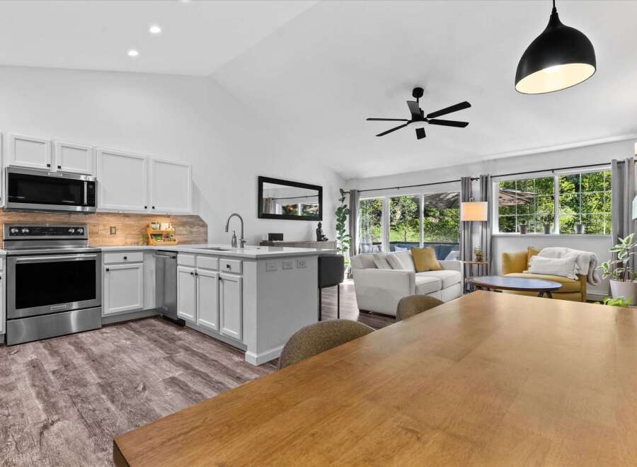 Experience modern living in this open-concept home featuring a sleek, updated kitchen with stainless steel appliances and ample cabinet space.