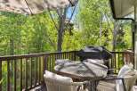 Enjoy outdoor living on this charming deck, perfect for entertaining or relaxing amidst lush greenery.