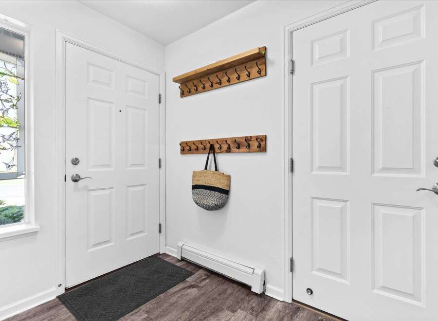 Welcome guests into this charming entryway featuring a stained-glass window with delicate hummingbird designs.