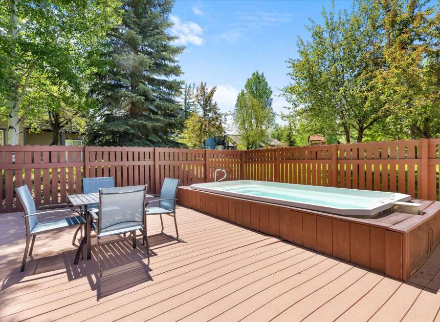 Enjoy outdoor living at its finest with this spacious deck featuring a luxurious hot tub, perfect for relaxation and entertaining.