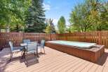 Enjoy outdoor living at its finest with this spacious deck featuring a luxurious hot tub, perfect for relaxation and entertaining.