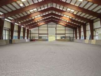 This expansive indoor arena offers a versatile space for equestrian activities.