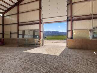 Discover the expansive potential of this equestrian property, featuring a large indoor arena perfect for year-round training.