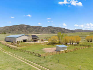 Discover your dream ranch property! This stunning estate features a spacious barn, a charming house, and expansive green pastures perfect for horses or livestock.