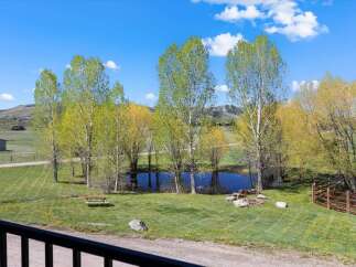 Discover your dream property! This stunning estate boasts a serene pond, perfect for peaceful moments.