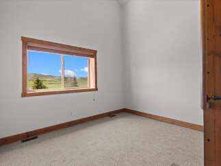 This bright and airy room features a large window that offers stunning views of the surrounding landscape.