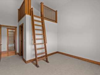 This unique property features a charming loft area accessible by a wooden ladder, perfect for a cozy retreat or additional living space.