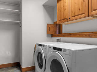 This laundry room features a modern design with a Whirlpool washer and dryer set.