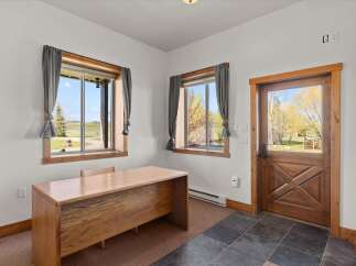 Step into this inviting office space, bathed in natural light from the expansive windows.