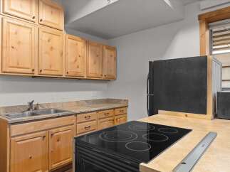This charming kitchen boasts beautiful wooden cabinetry, offering ample storage space.