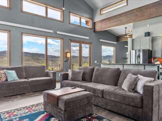 Experience luxury living in this stunning property featuring expansive windows that frame breathtaking mountain views.